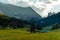 Landscape of Dolomites with green meadows, blue sky, white clouds and rocky mountains. Italian Dolomites landscape. Beauty of natu