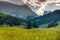 Landscape of Dolomites with green meadows, blue sky, white clouds and rocky mountains. Italian Dolomites landscape. Beauty of natu