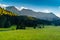 Landscape of Dolomites with green meadows, blue sky, white clouds and rocky mountains. Italian Dolomites landscape. Beauty of natu