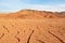 The landscape of dry mountains and mud cracked pattern on desert ground