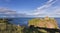 Landscape of Dunnottar Castle ruins withh dark clouds and ocean