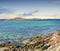 Landscape of empty rocky sea or river shore on summer day outside. Calm serene horizon, vibrant peaceful nature ocean