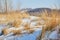 Landscape of fall grasses and snow on sand dunes