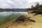 Landscape with fallen trees and reflections in the water of Ticha Dam