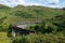 The landscape with famous Glenfinnan Viaduct in Scotland with a historic steam train in the background in nice summer sunny