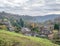 Landscape of a farm surrounded by houses and greenery under a cloudy sky in Ironbridge