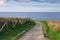 Landscape with fenced path for walking on the coast at sunset