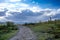 Landscape with field and road, monument on the horizon