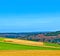 landscape with fields and a village with hills