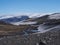 Landscape of Fimmvorduhals hiking trail. Eyjafjallajokull glacier and volcano, lava ash, blue stream from melting snow