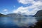 Landscape on the fjord in Norway from the seashore, the mountain on the other side, blue clear water