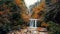 Landscape of flowing waterfalls surrounded with autumn trees in a forest