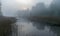 Landscape with fog in the morning, mystical fog on the river, blurred grass and tree contours