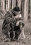 Landscape with a forester in the woods by the fire, a worker drinks tea and warms up by the fire, sepia