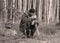 Landscape with a forester in the woods by the fire, a worker drinks tea and warms up by the fire, sepia