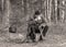 Landscape with a forester in the woods by the fire, a worker drinks tea and warms up by the fire, sepia