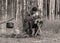 Landscape with a forester in the woods by the fire, a worker drinks tea and warms up by the fire, sepia