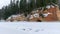 Landscape with frozen river Gauja near Gudu cliffs, view of sandstone cliff from the opposite bank of the river, beautiful red