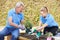 Landscape Gardeners Planting In Flower Bed