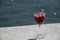 Landscape of glass of sangria on a ledge near water in summer in Lisbon Portugal