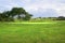 Landscape of a golf course, green, trees and hills