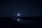 Landscape of gorgeous full moon over the snow-capped mountains reflected in the lake or mysterious night sky with full moon.