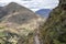 Landscape with green Andean Mountains and Inca ruins on the hiking path in Pisac archeological park, Peru