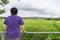 Landscape of green forest with back of asian man tourist traveller in the mountain