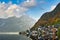 The landscape of Hallstatt, Austria, a riverside village reflecting the calm waters. The shadows in the water look like a mirror