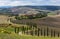 Landscape of hills, country road, cypresses trees and rural houses,Tuscany