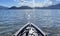 Landscape horizontal outdoor kayaking water sport adventure on ocean with mountain and blue sky