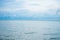 Landscape horizontal skyline of ocean and calm sea with clouded sky in background
