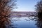 Landscape with a huge lake at the end of the autumn season. rocky mountains and high forests on the distant horizon. silhouettes o