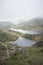 Landscape image of Glaslyn and Llyn Llydaw in Snowdonia with Glyder Fawr in the background with fog