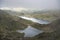 Landscape image of Glaslyn and Llyn Llydaw in Snowdonia with Glyder Fawr in the background with fog