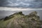 Landscape image looking out to sea with stormy sky