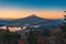 Landscape image of Mt. Fuji over Lake Kawaguchiko with autumn foliage at sunrise in Fujikawaguchiko, Japan