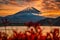 Landscape image of Mt. Fuji over Lake Motosu with autumn foliage at sunset in Yamanashi, Japan