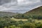 Landscape image of view from Precipice Walk in Snowdonia overlooking Barmouth and Coed-y-Brenin forest during rainy afternoon in