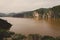 Landscape including calm brown water of Lake Nyos, famous for CO2 eruption with many deaths, Ring Road, Cameroon