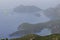 Landscape: islands in the sea and mountains, fog over the sea