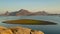 Landscape of Jawai dam with water, clear blue sky and Aravalli mountain ranges