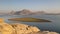 Landscape of Jawai dam with water, clear blue sky and Aravalli mountain ranges