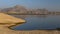 Landscape of Jawai dam with water, clear blue sky and Aravalli mountain ranges
