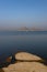 Landscape of Jawai dam with water, clear blue sky and Aravalli mountain ranges