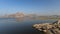 Landscape of Jawai dam with water, clear blue sky and Aravalli mountain ranges