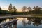 Landscape of the lake at colorful sunset with footbridge