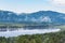 Landscape with a lake and mountains shrouded in fog.