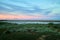 Landscape with lake, steppe, grass and blue sky with white clouds in autumn or summer evening