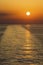 Landscape of a large boat wake on ocean at sunset